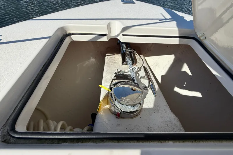 Slide: The Image of Anchor compartment of 2023 Cobia 280 Center Console boat, open hatch view. - 41