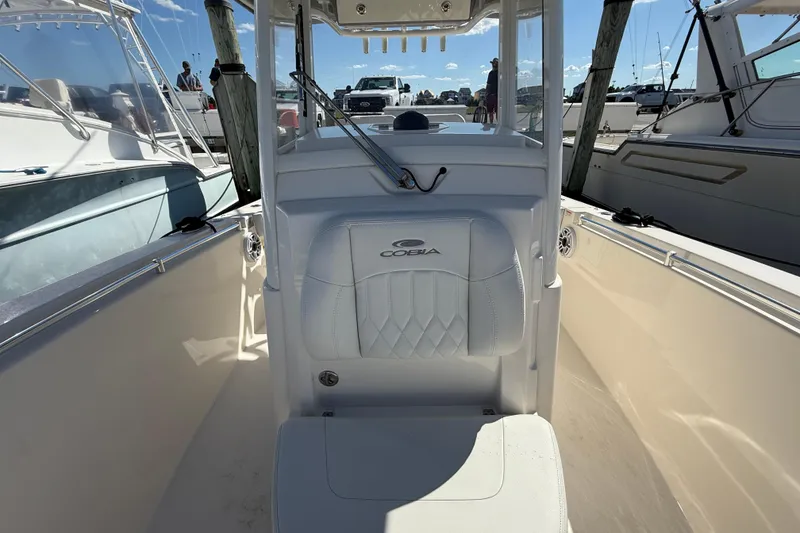 Slide: The Image of 2023 Cobia 280 Center Console boat interior with white seating and console. - 44