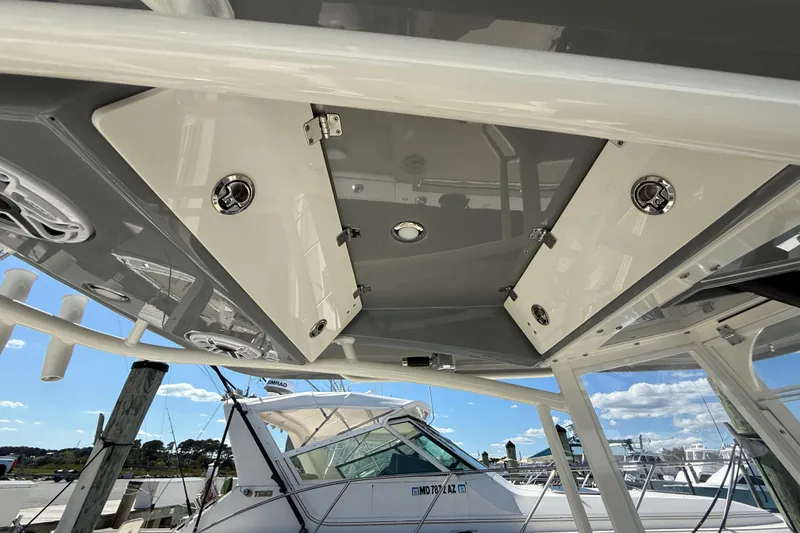 Slide: The Image of 2023 Cobia 280 Center Console boat interior with storage compartments and speakers. - 50