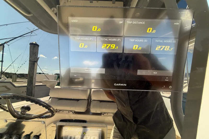 Slide: The Image of Garmin display on 2023 Cobia 280 Center Console showing trip and total hours. - 52