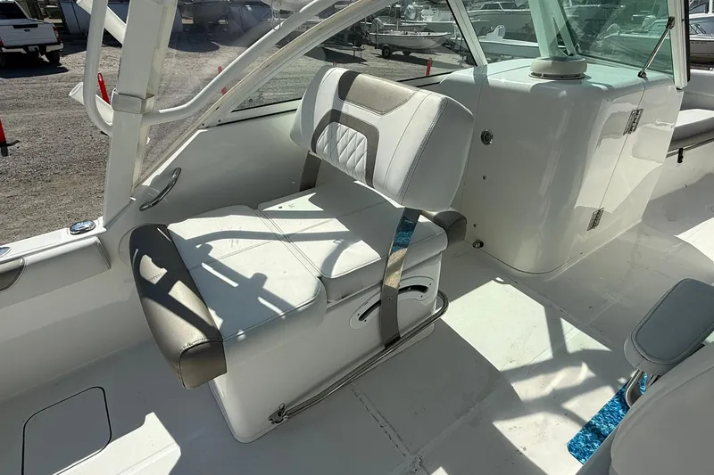 Slide: The Image of 2023 World Cat 230 DC boat interior with white seating and modern design. - 10