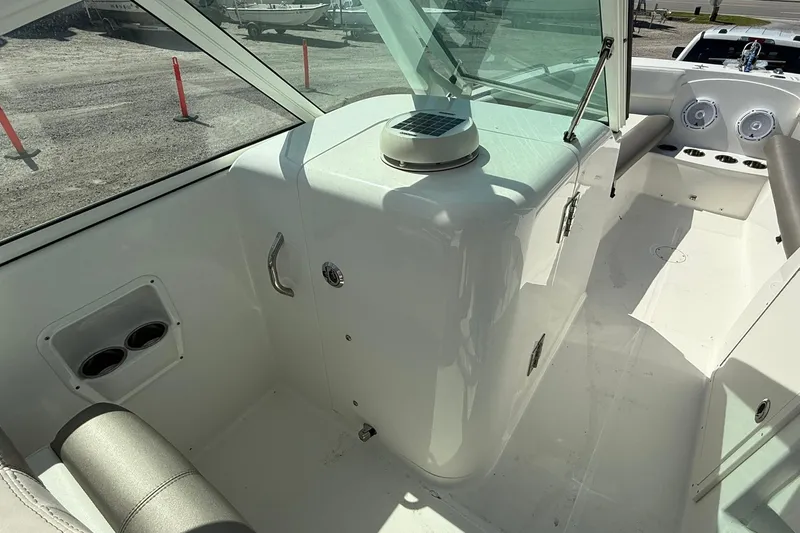Slide: The Image of 2023 World Cat 230 DC boat interior with seating and dashboard view. - 13