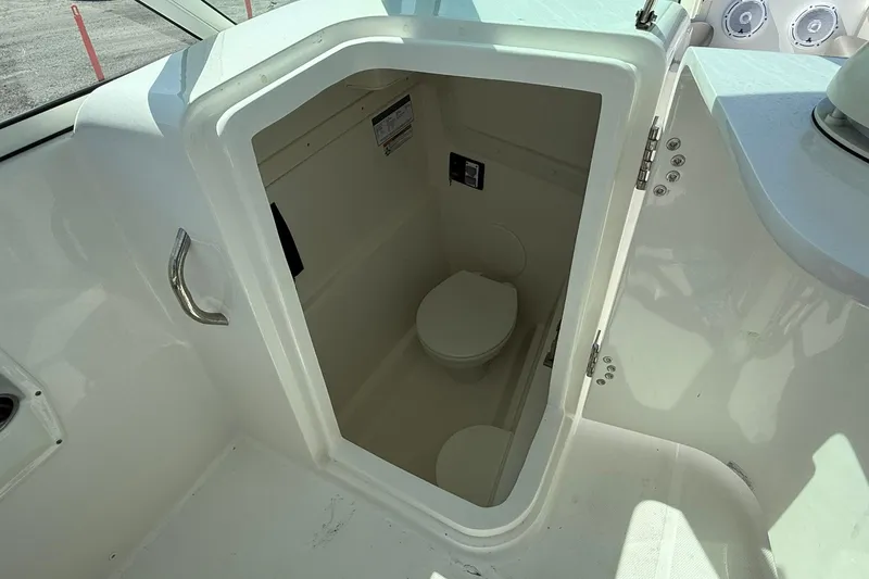 Slide: The Image of 2023 World Cat 230 DC boat interior with compact marine toilet. - 14