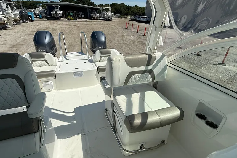 Slide: The Image of 2023 World Cat 230 DC boat interior with dual engines and seating. - 15