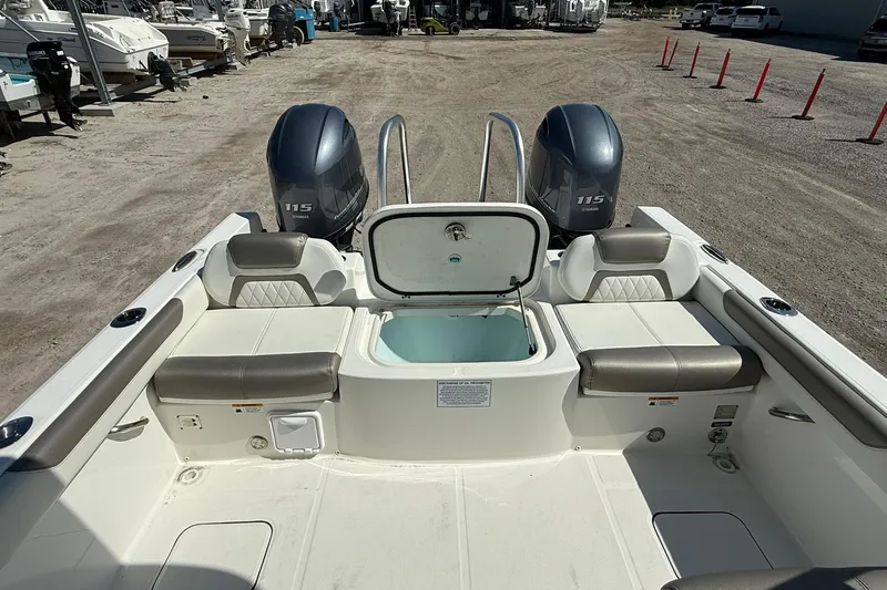 Slide: The Image of 2023 World Cat 230 DC boat interior with dual Yamaha 115 engines. - 17