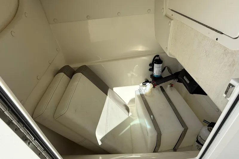 Slide: The Image of Interior of 2023 World Cat 230 DC boat, featuring storage and equipment compartments. - 18