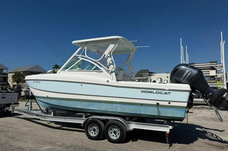 Slide: The Image of 2023 World Cat 230 DC boat on trailer, featuring Yamaha outboard motor. - 3