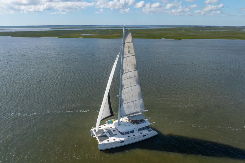 The Image of Aerial view of 2012 Lagoon 560 catamaran sailing on open water. - 0