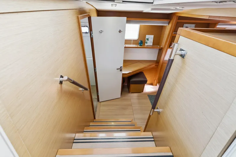 Slide: The Image of Interior view of 2012 Lagoon 560 yacht, featuring wooden stairs and modern cabin design. - 106
