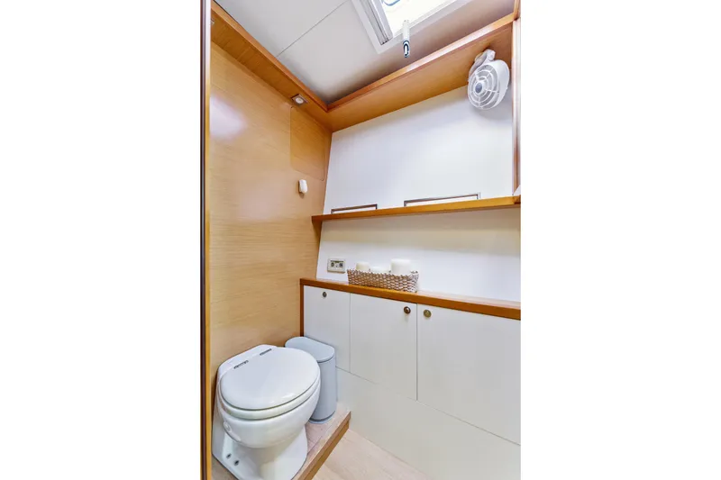 Slide: The Image of Modern bathroom interior on 2012 Lagoon 560 yacht, featuring wooden accents and compact design. - 116