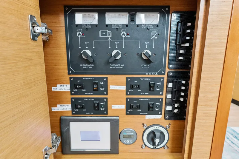 Slide: The Image of Control panel of a 2012 Lagoon 560 yacht, featuring switches and gauges. - 117
