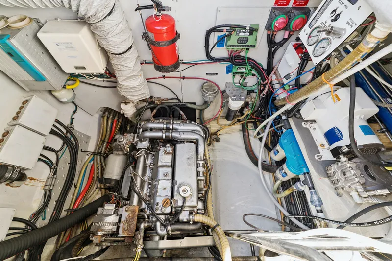 Slide: The Image of Engine room of a 2012 Lagoon 560 yacht, featuring complex machinery and wiring. - 122