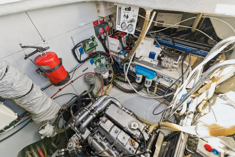 Slide: The Image of Engine room of 2012 Lagoon 560 yacht with fire extinguisher and mechanical components. - 123