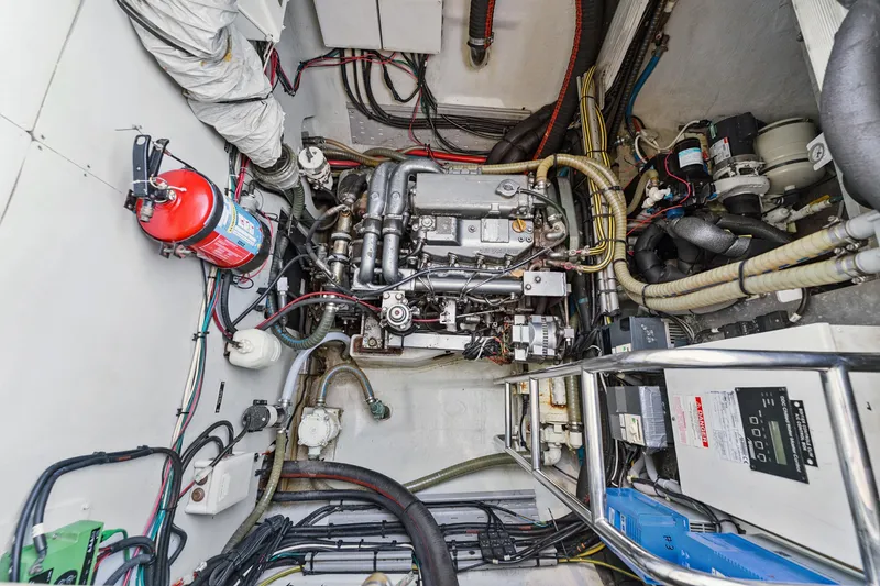 Slide: The Image of Engine room of a 2012 Lagoon 560 yacht, featuring complex machinery and wiring. - 124