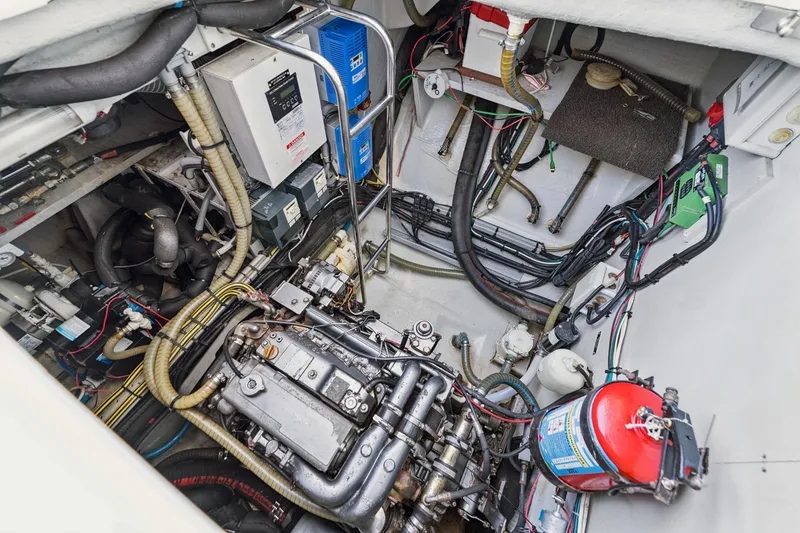 Slide: The Image of Engine room of a 2012 Lagoon 560 yacht, showcasing complex machinery and wiring. - 125