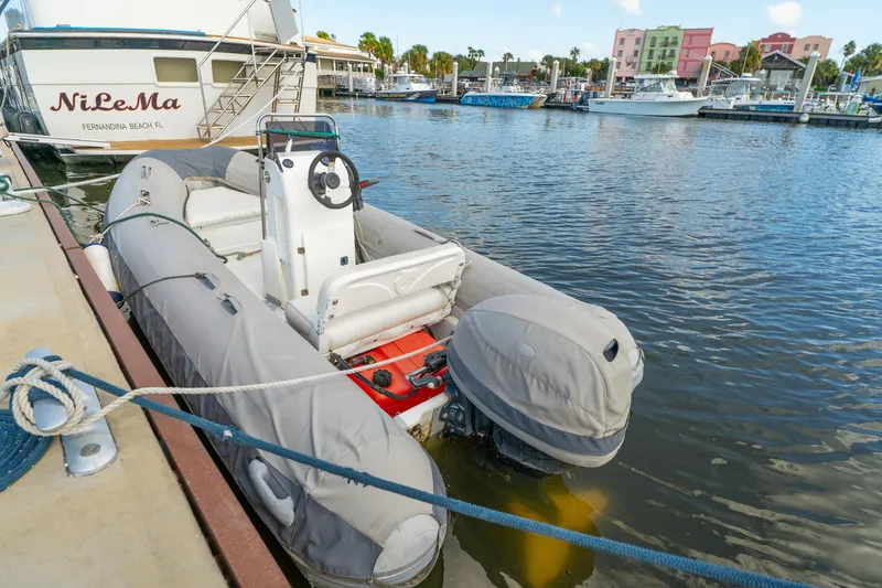 Slide: The Image of Inflatable boat docked near Lagoon 560 yacht, 2012 model, at marina. - 130