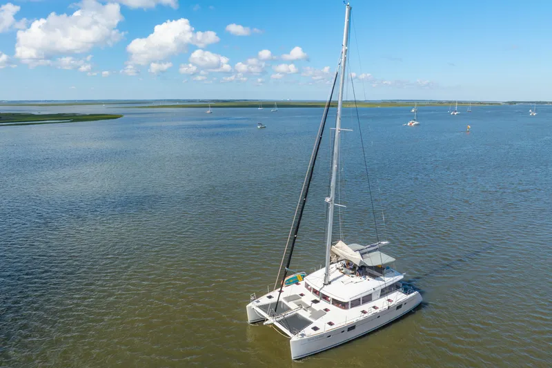 Slide: The Image of 2012 Lagoon 560 catamaran sailing on a calm sea under a clear blue sky. - 131