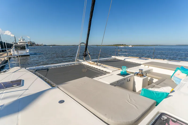 Slide: The Image of Luxurious 2012 Lagoon 560 yacht deck with seating, ocean view, and clear blue sky. - 14