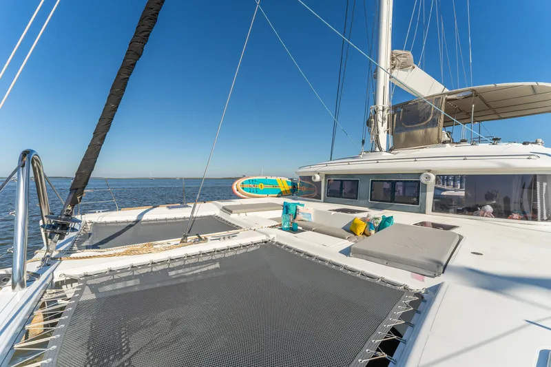 Slide: The Image of Luxurious 2012 Lagoon 560 catamaran with spacious deck and seating, sailing on open water. - 15