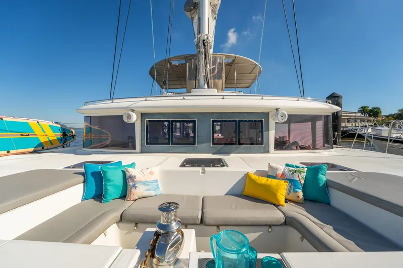 Slide: The Image of Luxurious 2012 Lagoon 560 yacht deck with colorful cushions and clear blue sky. - 20