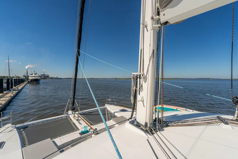 Slide: The Image of Lagoon 560 catamaran sailing on calm waters, 2012 model, clear blue sky. - 24