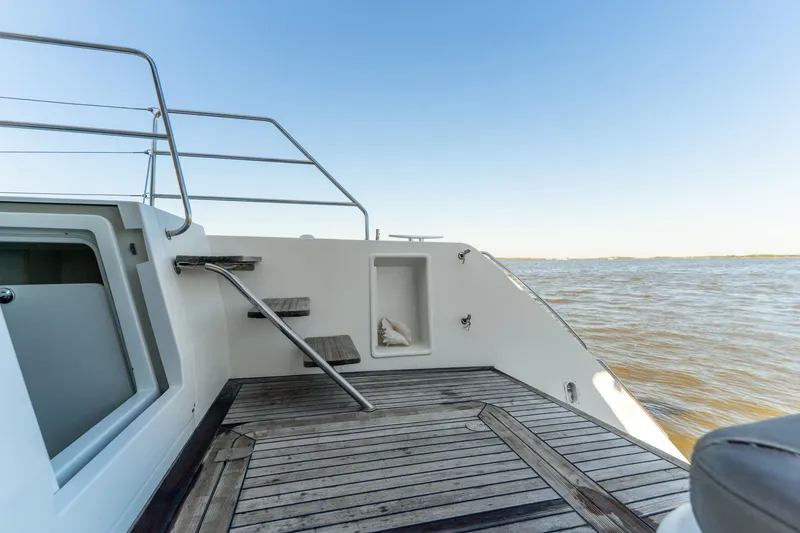 Slide: The Image of Lagoon 560 yacht deck, 2012 model, overlooking calm sea under clear blue sky. - 30