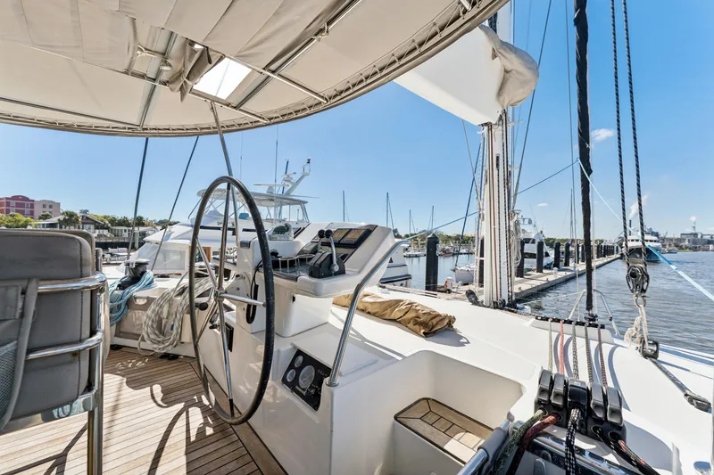 Slide: The Image of Luxurious 2012 Lagoon 560 catamaran docked at marina, featuring spacious helm and modern design. - 34