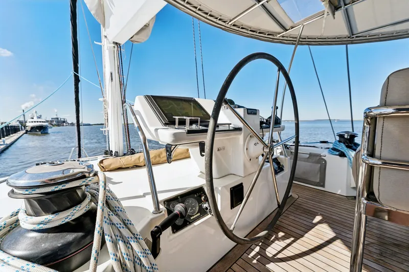 Slide: The Image of Steering wheel of 2012 Lagoon 560 yacht with ocean view and clear sky. - 40