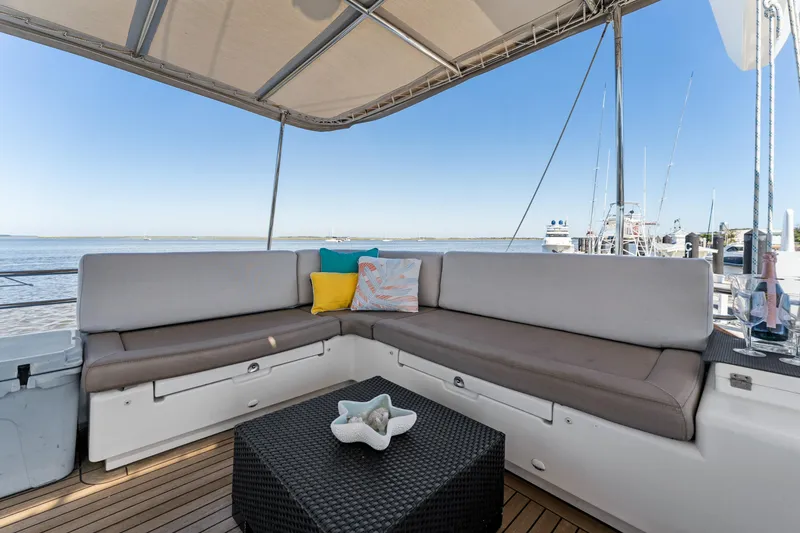 Slide: The Image of Luxurious seating area on 2012 Lagoon 560 yacht with ocean view and decorative pillows. - 41