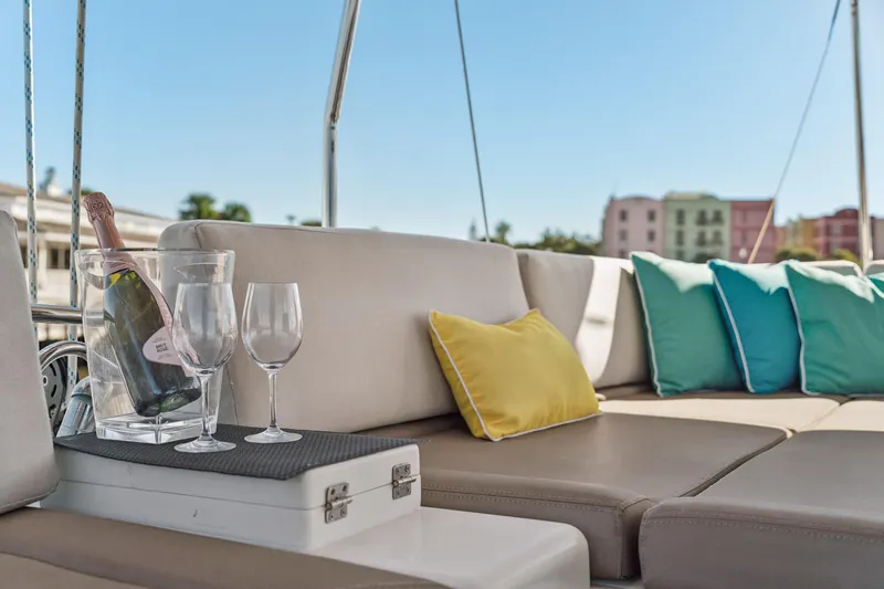 Slide: The Image of Luxurious Lagoon 560 yacht deck with champagne, glasses, and colorful cushions, 2012 model. - 43