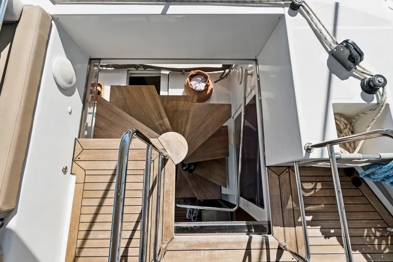 Slide: The Image of Staircase on 2012 Lagoon 560 yacht, featuring wooden steps and sleek design elements. - 46