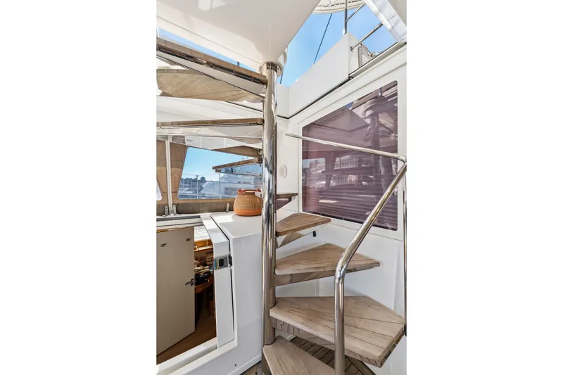 Slide: The Image of Interior view of 2012 Lagoon 560 yacht with spiral staircase and modern design. - 47