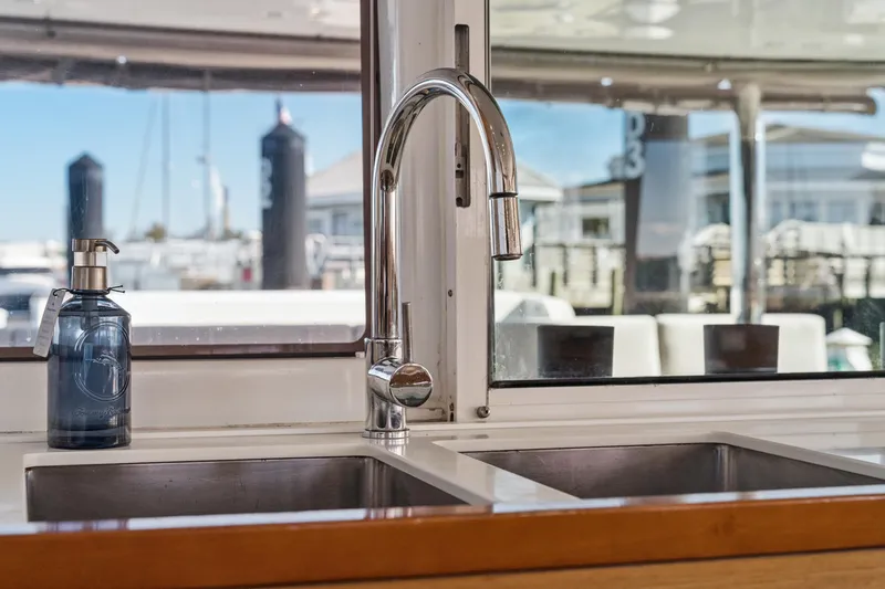 Slide: The Image of Modern kitchen sink and faucet on 2012 Lagoon 560 yacht, with marina view. - 58