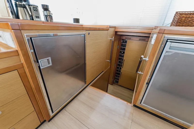 Slide: The Image of Luxurious 2012 Lagoon 560 yacht interior with modern kitchen and wine storage. - 64