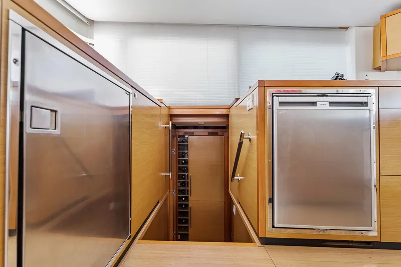 Slide: The Image of Interior of 2012 Lagoon 560 yacht featuring modern kitchen appliances and wooden cabinetry. - 65