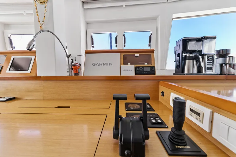 Slide: The Image of Control panel of 2012 Lagoon 560 yacht with Garmin navigation and coffee maker. - 72