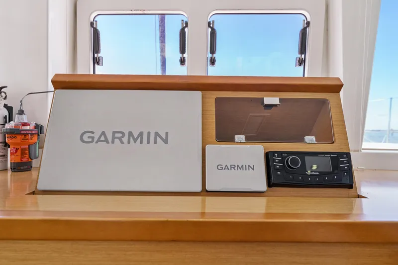 Slide: The Image of Garmin navigation system on 2012 Lagoon 560 yacht dashboard, featuring modern controls. - 73
