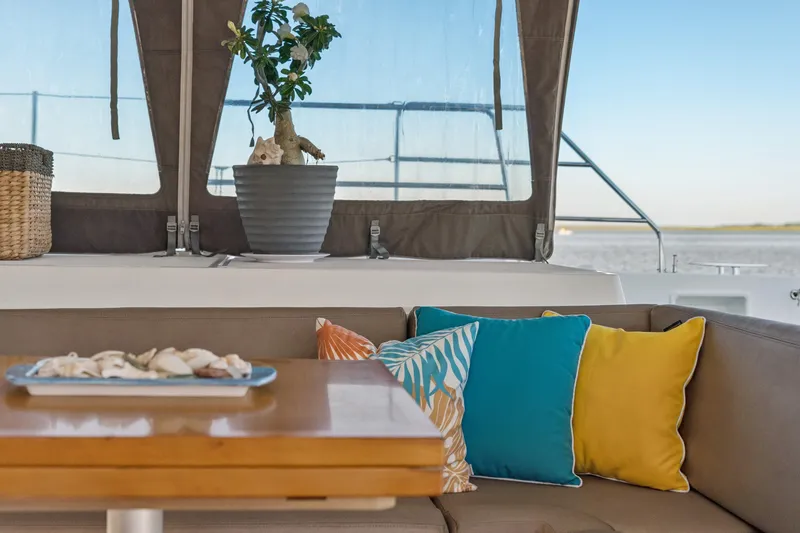 Slide: The Image of Cozy Lagoon 560 yacht interior with colorful cushions and potted plant, 2012 model. - 78