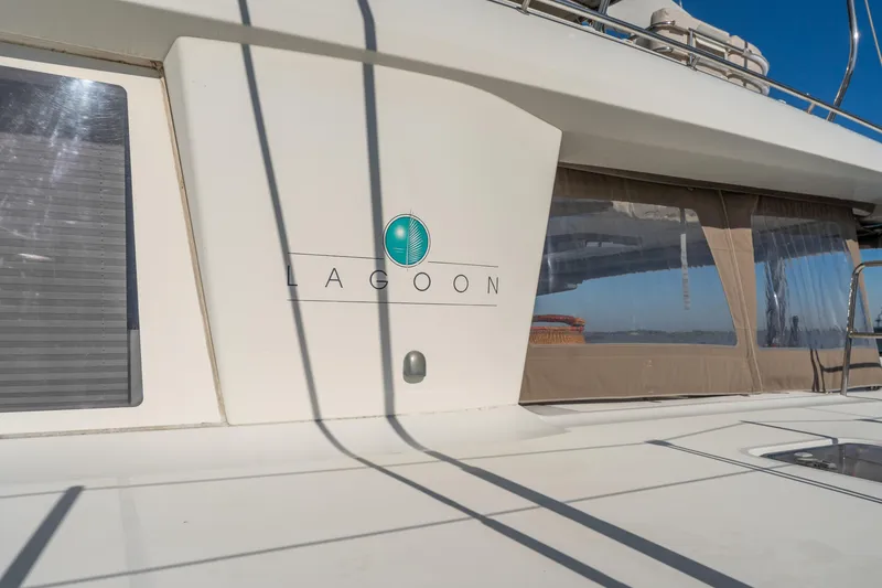 Slide: The Image of 2012 Lagoon 560 yacht exterior with logo and windows in sunlight. - 8