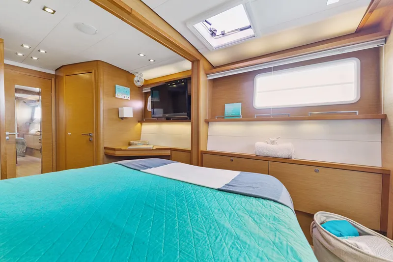 Slide: The Image of Luxurious interior of 2012 Lagoon 560 yacht with modern wood finish and cozy bedding. - 85