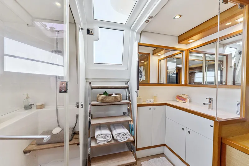 Slide: The Image of Luxurious 2012 Lagoon 560 yacht bathroom with modern fixtures and elegant wood accents. - 86