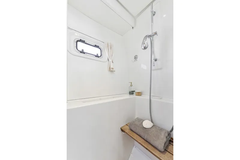 Slide: The Image of Luxurious bathroom in 2012 Lagoon 560 yacht with shower and porthole window. - 89