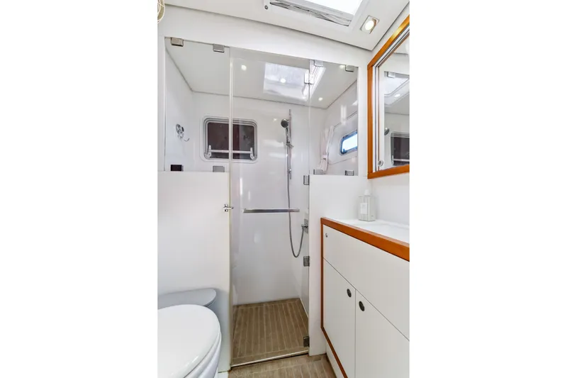 Slide: The Image of Modern bathroom interior on 2012 Lagoon 560 yacht, featuring shower and sleek cabinetry. - 94