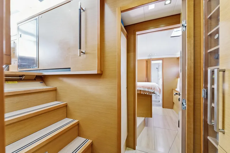 Slide: The Image of Interior of 2012 Lagoon 560 yacht, featuring wooden stairs and modern cabin design. - 99