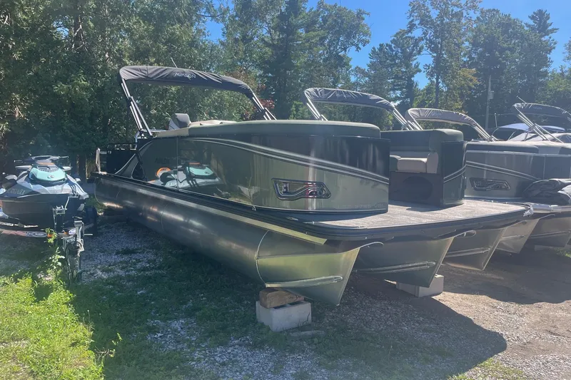 Slide: The Image of 2026 Avalon 25 LSZ Versatile Rear Lounger pontoon boat parked outdoors. - 10