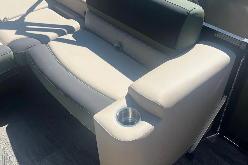Slide: The Image of 2026 Avalon 25 LSZ Versatile Rear Lounger with cup holder, beige and black seating. - 4