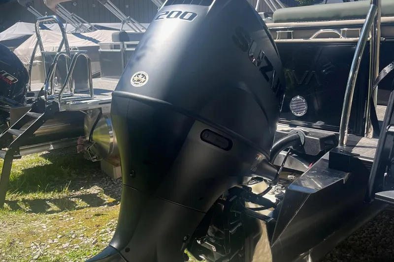 Slide: The Image of 2026 Avalon 25 LSZ Versatile Rear Lounger with Suzuki outboard motor, parked outdoors. - 9