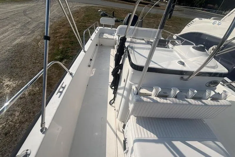 Slide: The Image of 2012 Boston Whaler 210 Montauk boat interior with seating and console, docked on land. - 11