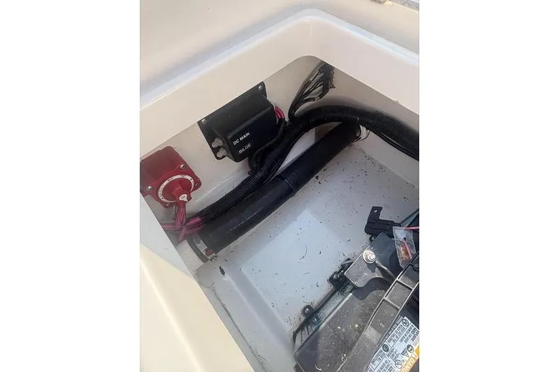 Slide: The Image of 2012 Boston Whaler 210 Montauk boat battery compartment with wiring and switches. - 12