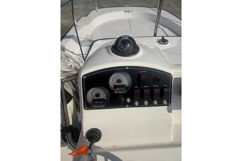 Slide: The Image of Control panel of a 2012 Boston Whaler 210 Montauk boat with gauges and compass. - 14